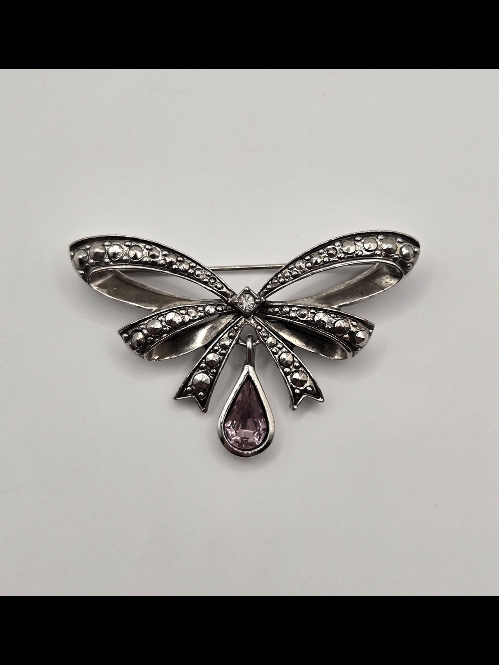 Silver Bow Brooch with Pink Teardrop Gem